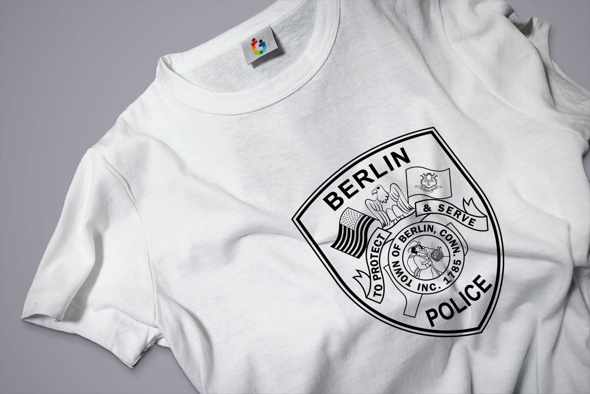 White t-shirt with a black police logo and text on a gray background