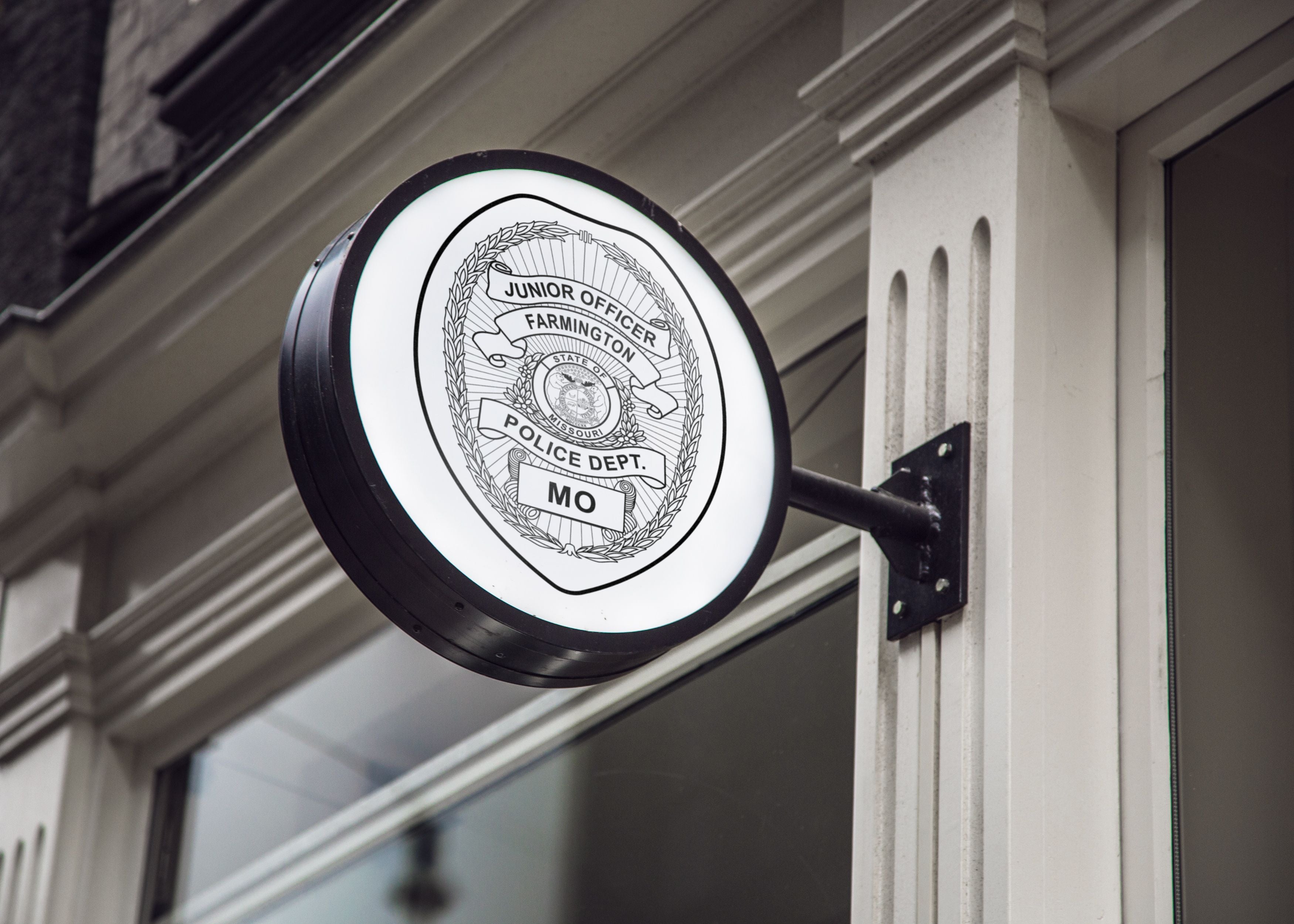 Round illuminated sign with police department logo on a building facade
Round illuminated sign with police department badge svg
Round illuminated sign with police badge mockup