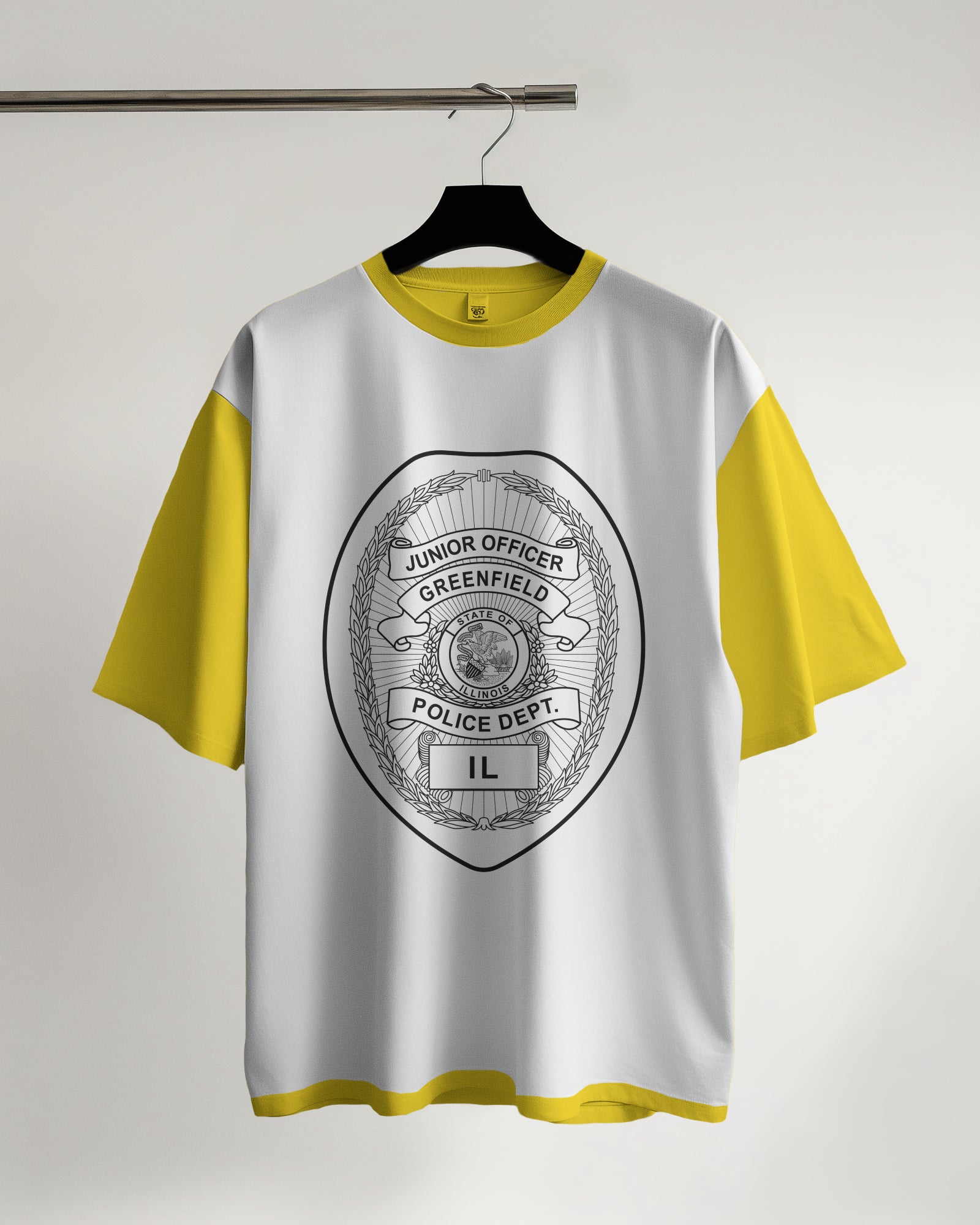 White t-shirt with yellow sleeves featuring a police department logo on a hanger against a white background
White t-shirt with yellow sleeves featuring a police department
