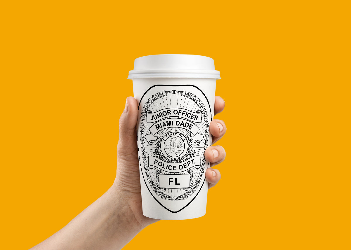 Hand holding a coffee cup with a Miami Dade Police Dept logo against an orange background.
Hand holding a coffee cup with a Miami Dade Police Dept Badge