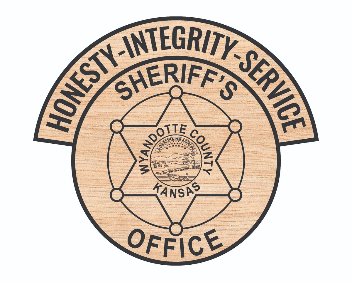 A circular wood-grain styled emblem featuring the text 'HONESTY - INTEGRITY - SERVICE' along the top arch and 'SHERIFF'S OFFICE' at the bottom, with 'MYNDOTTE COUNTY KANSAS' and a county seal in the center. The design is presented on a solid white background.